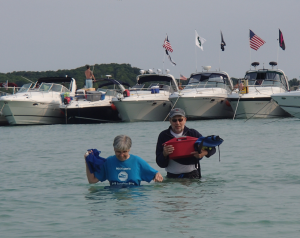 Three Lakes Association Water Quality Chair, Becky Norris and Torch Lake Protection Alliance Board Member Gary Petty collecting water samples on July 3rd, 2015 the Sand Bar.